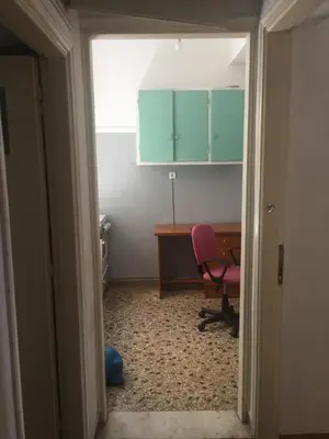 a room with a desk and a pink chair at Simple & Spacious - Shared Accomodation in Athens