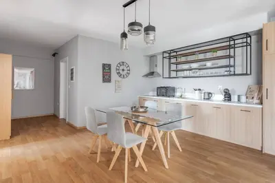 a kitchen and dining room with a table and chairs at Charming Acropolis view modern design House 2BD in Athens