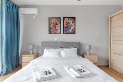 a bedroom with a white bed with two towels on it at Charming Acropolis view modern design House 2BD in Athens