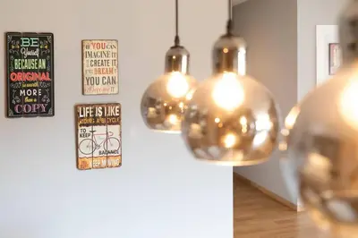 a group of lights hanging from a wall at Stunning Acropolis view modern design house 2BD in Athens