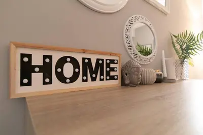 a home sign on a shelf in a room at Stunning Acropolis view modern design house 2BD in Athens