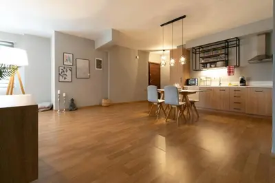 a large living room with a table and chairs at Stunning Acropolis view modern design house 2BD in Athens
