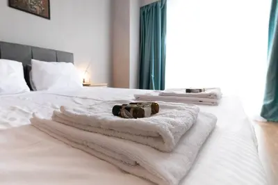 a bedroom with white towels on a bed at Stunning Acropolis view modern design house 2BD in Athens
