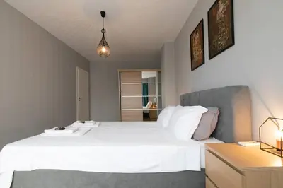 a bedroom with a large white bed and a desk at Stunning Acropolis view modern design house 2BD in Athens