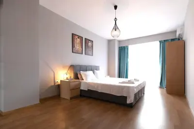 a bedroom with a bed and a large window at Stunning Acropolis view modern design house 2BD in Athens
