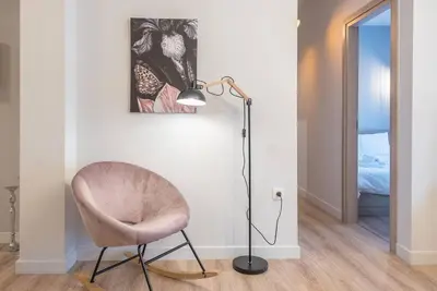 a floor lamp and a chair in a room at Urban & Spacious Apartment in Athens