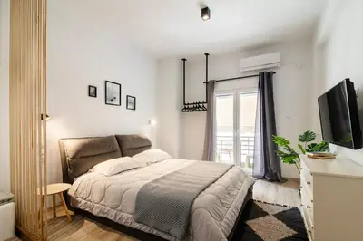 a white bedroom with a bed and a window at Acropolis Hidden Gem- The perfect Athenian Hideaway in Athens