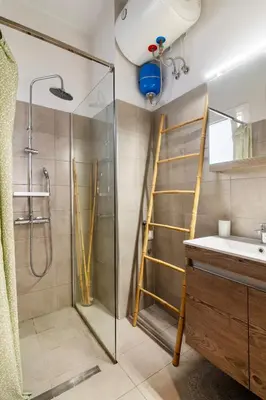 a bathroom with a shower and a sink and a ladder at Acropolis Hidden Gem- The perfect Athenian Hideaway in Athens