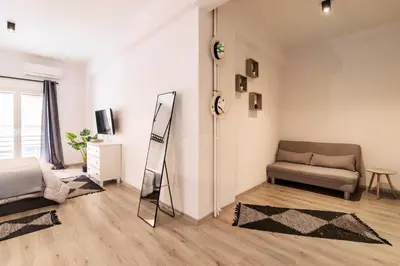 a living room with a couch and a mirror at Acropolis Hidden Gem- The perfect Athenian Hideaway in Athens