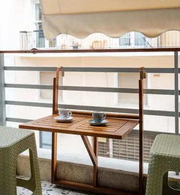 a wooden table with two cups on it next to a window at Acropolis Hidden Gem- The perfect Athenian Hideaway in Athens