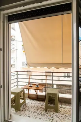 a balcony with a table and two chairs and a table at Acropolis Hidden Gem- The perfect Athenian Hideaway in Athens