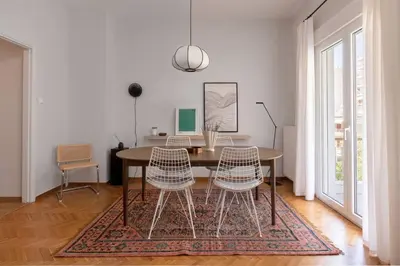 a dining room with a table and two chairs at Faliro Serenity 2BD Apartment by UPSTREET in Athens