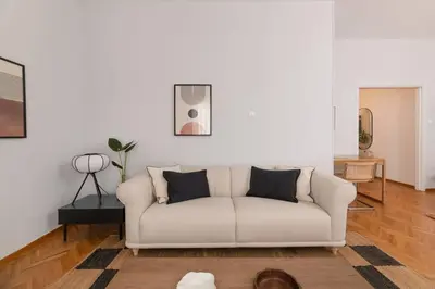 a living room with a white couch and a table at Faliro Serenity 2BD Apartment by UPSTREET in Athens