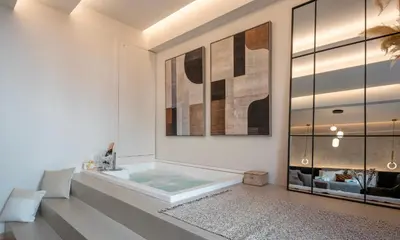a bathroom with a soaking tub in the floor at Derouse Eva Suite Jacuzzi & Sauna in Athens