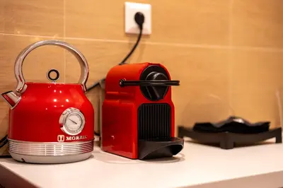 a red toaster sitting on top of a counter at Derouse Eva Suite Jacuzzi & Sauna in Athens