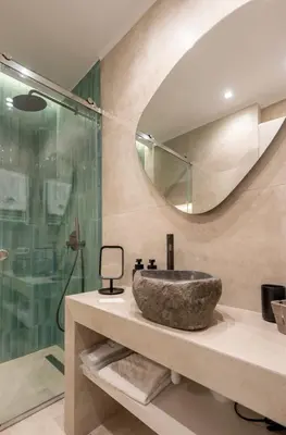 a bathroom with a stone sink and a shower at Derouse Eva Suite Jacuzzi & Sauna in Athens