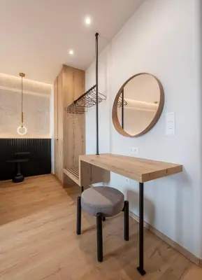a dressing room with a table and a mirror at Derouse Eva Suite Jacuzzi & Sauna in Athens