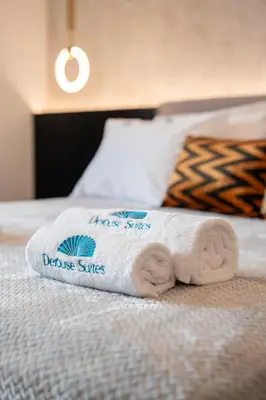 a towel sitting on top of a bed at Derouse Eva Suite Jacuzzi & Sauna in Athens