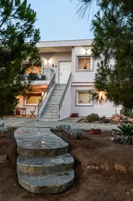 a house with a staircase in front of it at Marina's dream house in Sounio