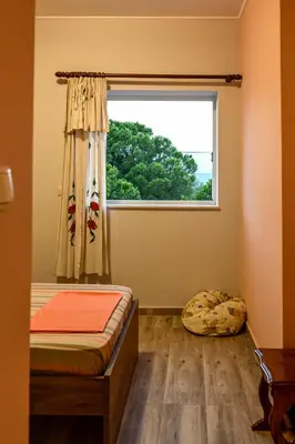 a bedroom with a bed and a window at Marina's dream house in Sounio