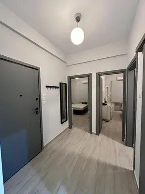 an empty room with doors and a hallway with a bed at Koukaki Urban Living Apartment in Athens