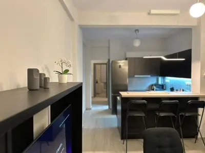 a kitchen with a counter and chairs in a room at Koukaki Urban Living Apartment in Athens