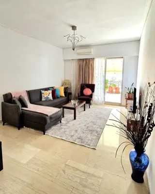 a living room with a couch and a table at Aphrodite's Nest in Athens
