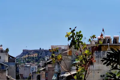 a city with buildings and a mountain in the background at Aphrodite's Nest in Athens