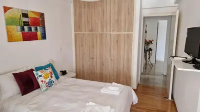a small room with a bed and a tv at Aphrodite's Nest in Athens