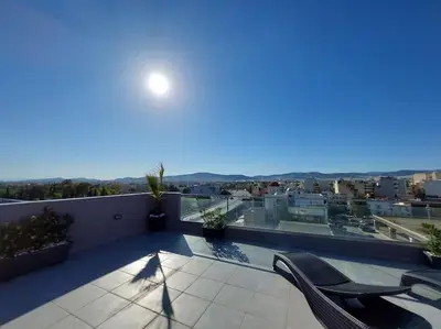 a balcony with chairs and a view of a city at Modern Apartment in Athens