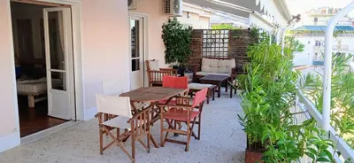 a patio with a table and chairs on a balcony at Flat 32 penthouse in Athens