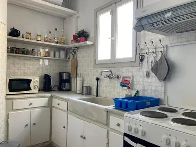 a white kitchen with a sink and a stove at Flat 32 penthouse in Athens