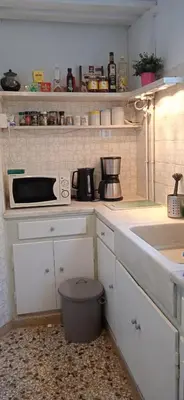 a kitchen with a sink and a microwave at Flat 32 penthouse in Athens