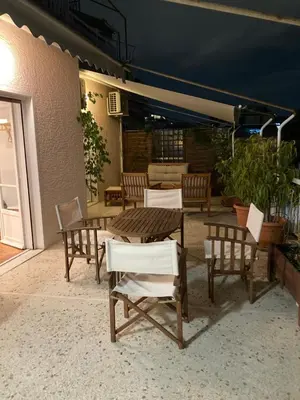 a wooden table and chairs on a patio at Flat 32 penthouse in Athens