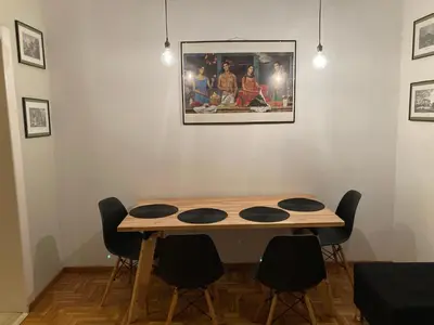 a table in a room with a picture on the wall at Flat 32 penthouse in Athens
