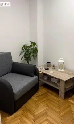 a living room with a couch and a coffee table at Cozy Nest at Lykavitos in Athens