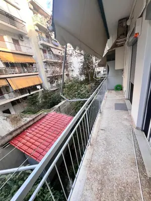 a balcony of a building with a red walkway at Cozy Nest at Lykavitos in Athens