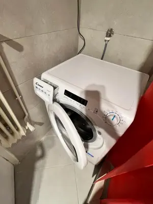a washing machine is sitting in a room at Cozy Nest at Lykavitos in Athens