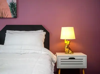 a bedroom with a bed with a lamp on a night stand at City Romance in Athens