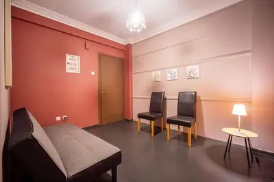a room with two chairs and a bed and a table at City Romance in Athens
