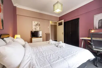 a bedroom with a large white bed and a desk at City Romance in Athens