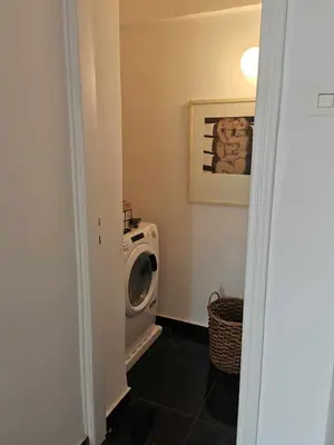 a laundry room with a washing machine in it at Odel in Athens