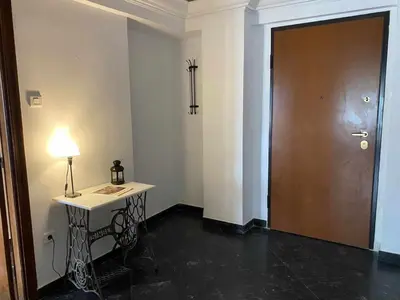 a room with a door and a table with a lamp at Odel in Athens