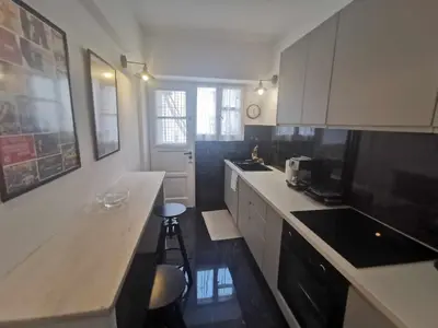 a kitchen with white cabinets and a counter top at Odel in Athens