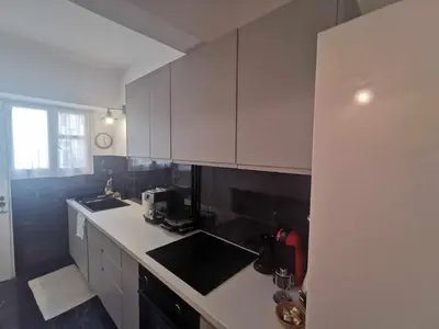 a kitchen with white cabinets and a white counter top at Odel in Athens