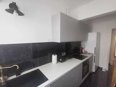 a kitchen with white cabinets and a sink at Odel in Athens