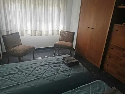 a bedroom with two chairs and a bed and a dresser at Odel in Athens