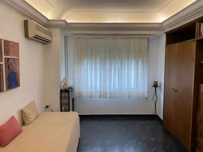 a living room with a couch and a window at Odel in Athens