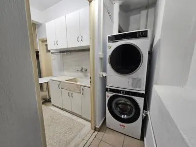 a washer and dryer in a small kitchen at Athens Vibes Apartment by YHA in Athens