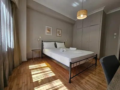 a bedroom with a large white bed in a room at Athens Vibes Apartment by YHA in Athens